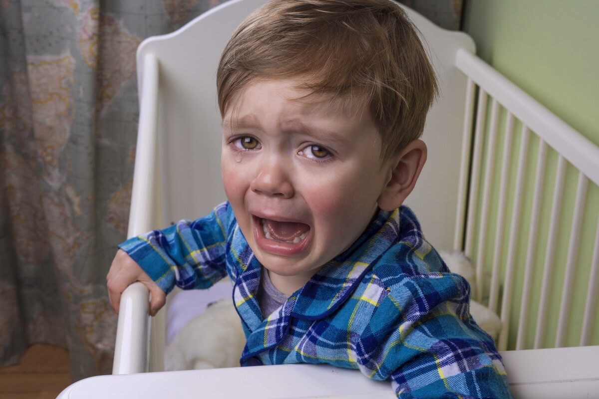 Child crying in a cot