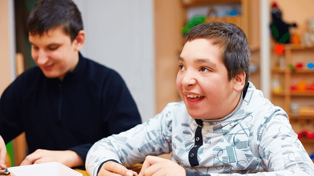 smiling teenage boy with a disability