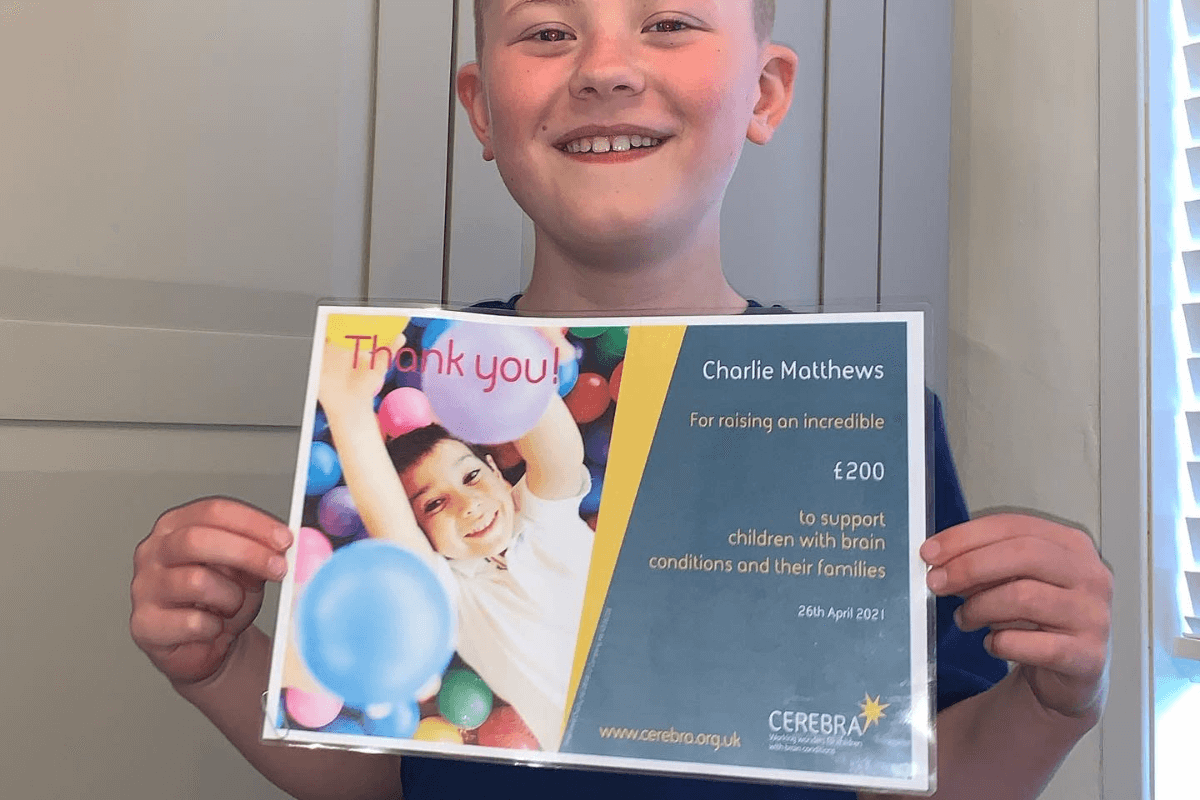 Charlie with his certificate from Cerebra