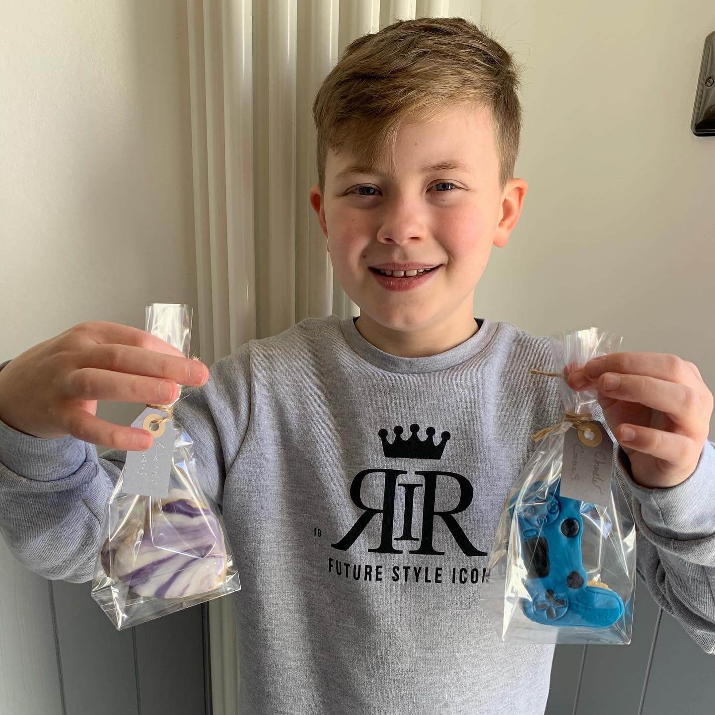 Charlie holding his bags of home made cookies