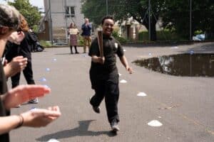 Child on school playground running with Relay baton