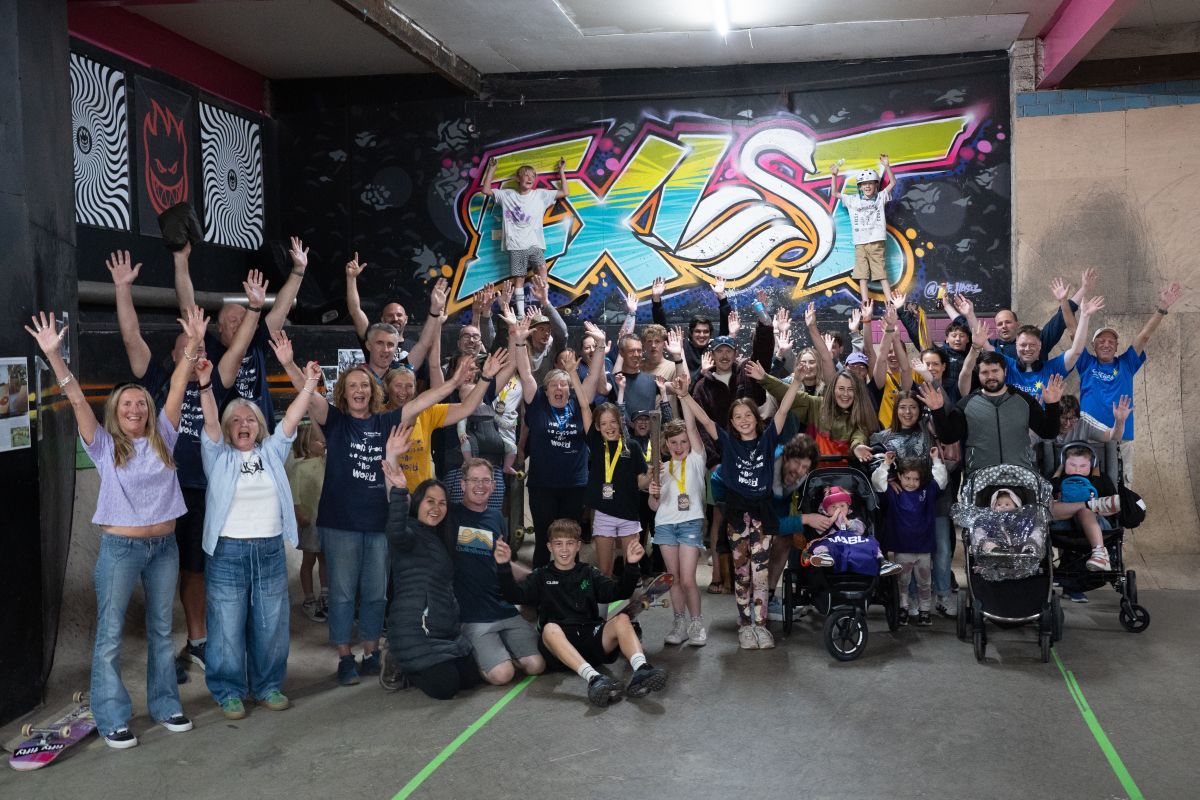 Group of adults and children of all ages at Exist indoor skate park