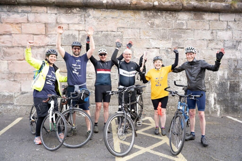 Two sets of tandem bikers from In-Tandem East Lothian with their tandem bikes, and Cerebra CEO Jess Camburn-Rahmani and her brother Mark