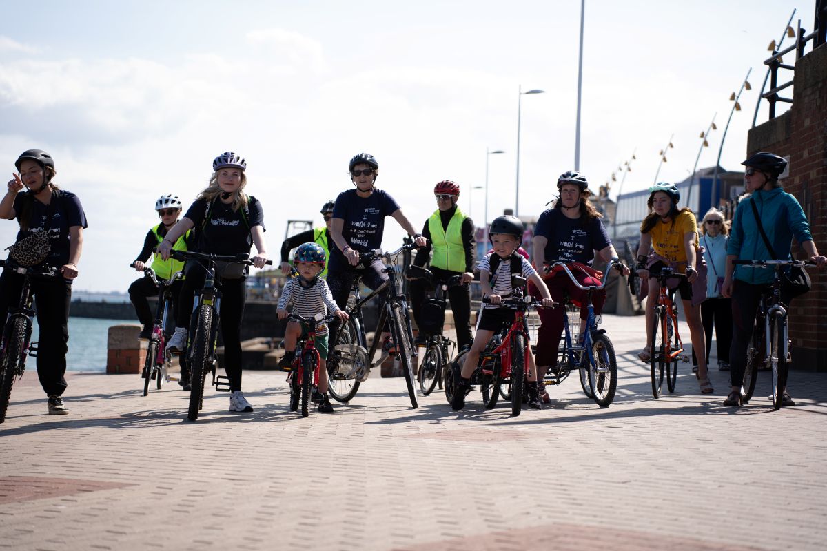 Group of cyclists led by the brilliant Henry, proudly pulling the baton in his new Cerebra bike trailer