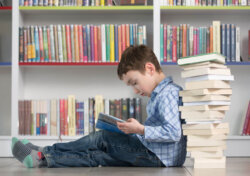 Cerebra library a child reading books from the library.