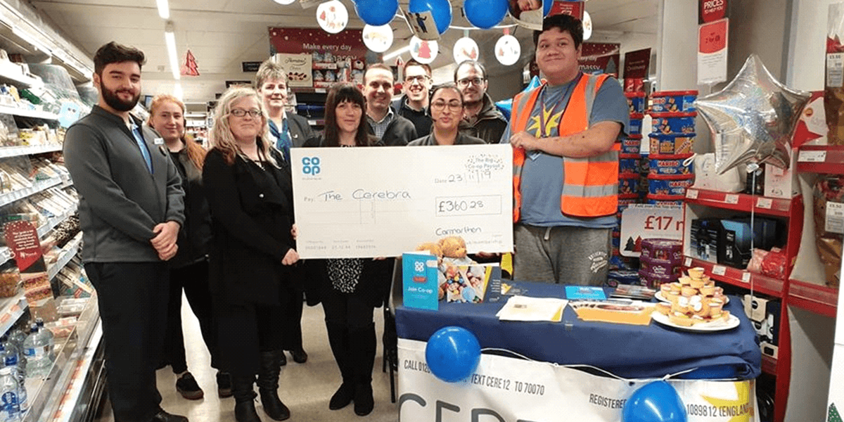 Samuel Turner collecting a cheque from Co Op