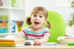 happy little girl with books
