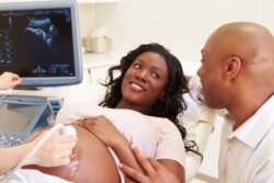 pregnant woman and partner at a scan