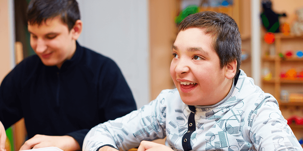 smiling teenage boy with a disability