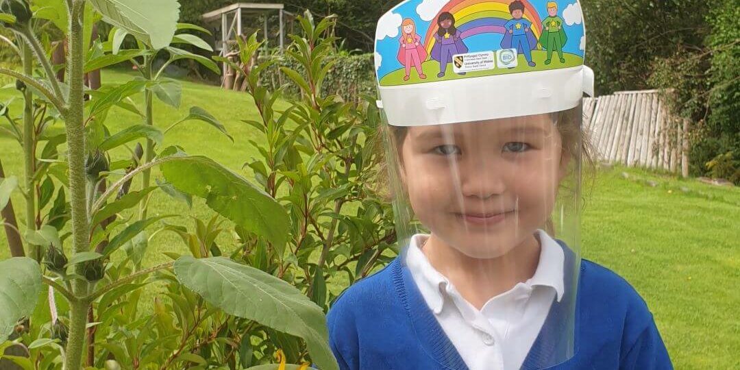 little girl wearing a bright coloured visor